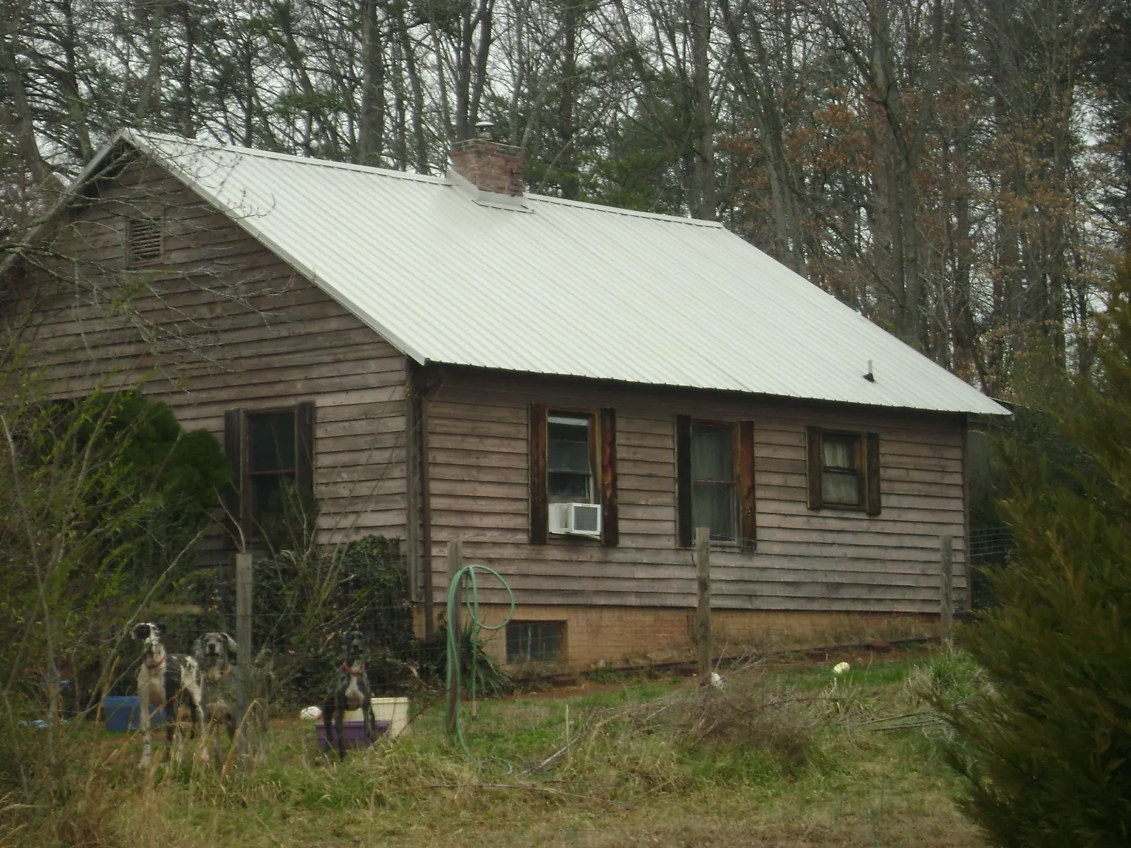 White metal roof on an old wood sided farmhouse, from a Metal Roof Installation job in Lorimor